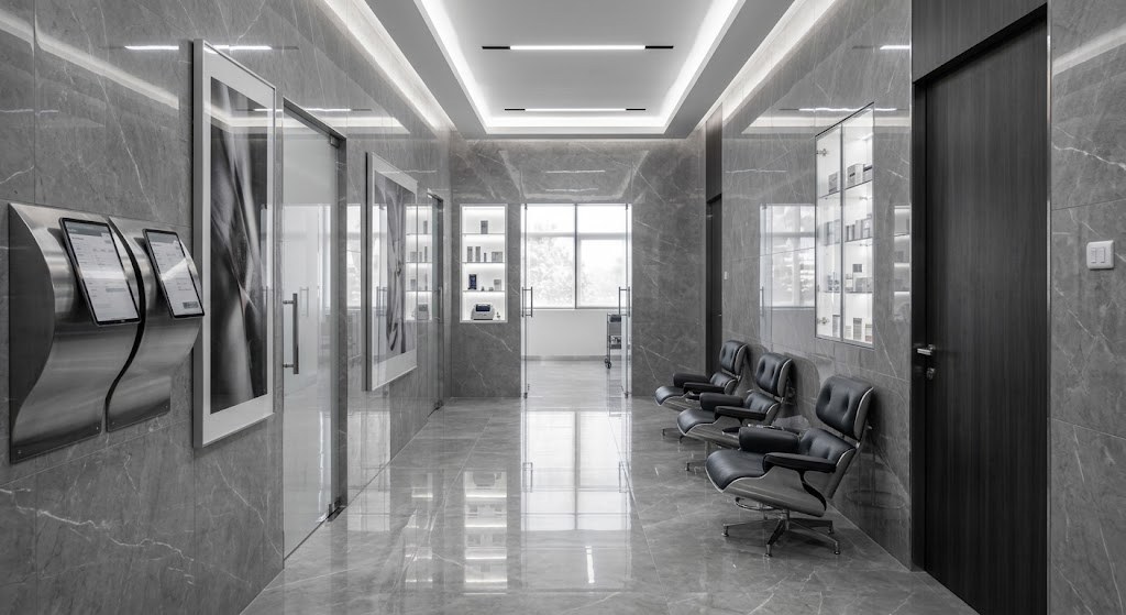 A quiet private clinic corridor, stone floors and seating along one wall
